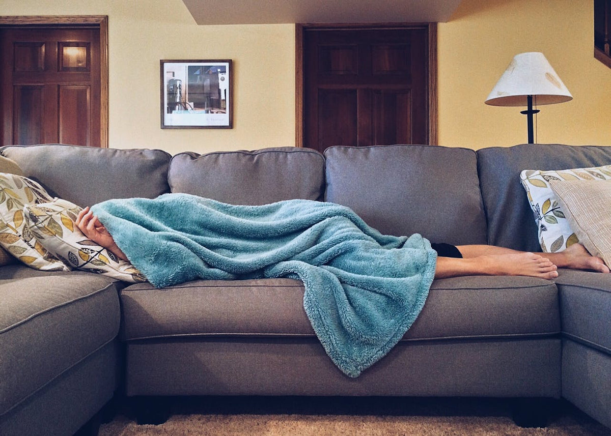 man sleeping on couch