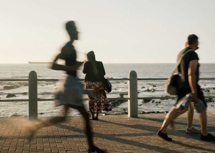 Woman standing on background while people walking on promenade