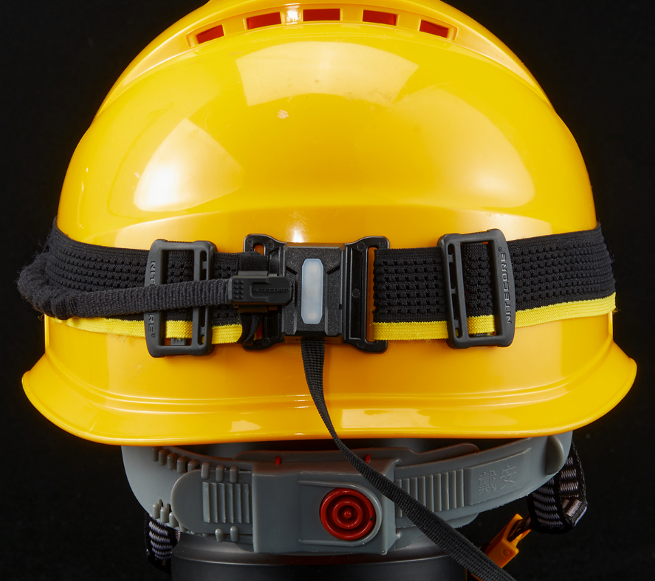 Nitecore HU2000 headband and power cable mounted on the back of a yellow hard hat