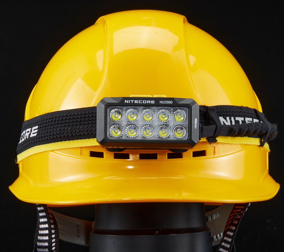 Nitecore HU2000 front view of the headlamp mounted on a yellow hard hat